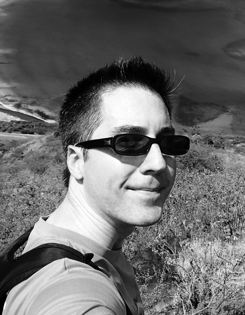 Jason Hanley on a hillside above the water